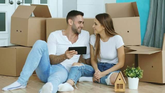 Couple settling into a new home among moving boxes