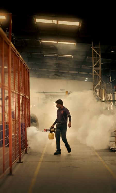 Pest-control specialist fogging a commercial facility