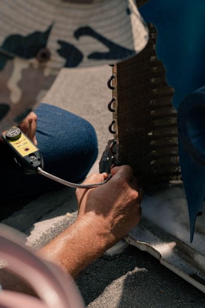 Technician servicing a home air conditioner